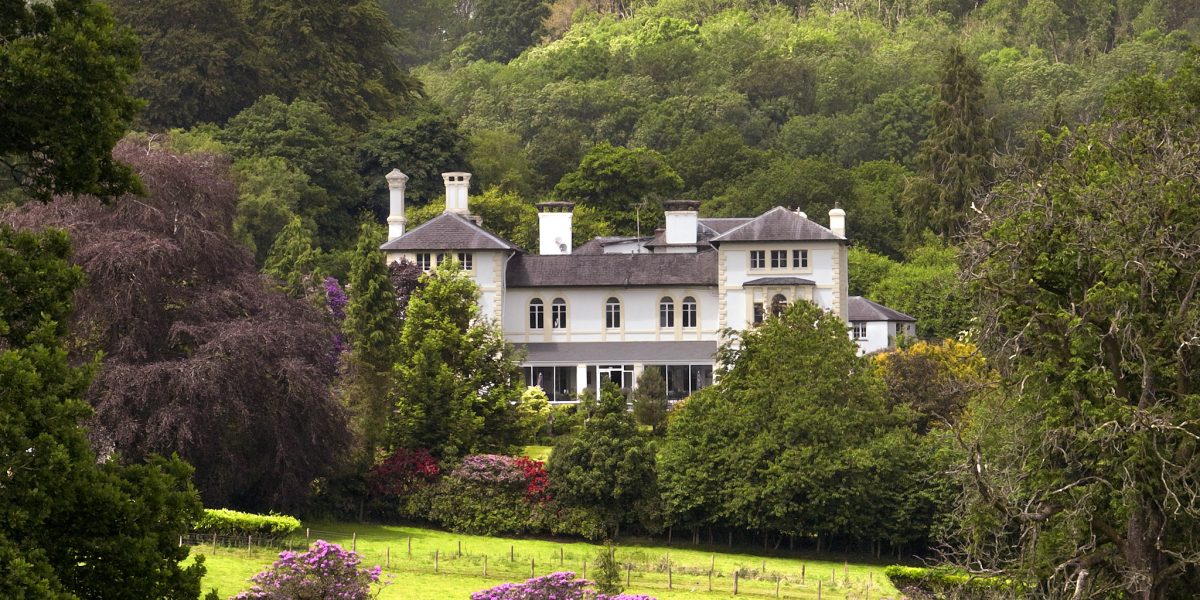 Countryside Mansion surrounded by trees and gardens in Wales