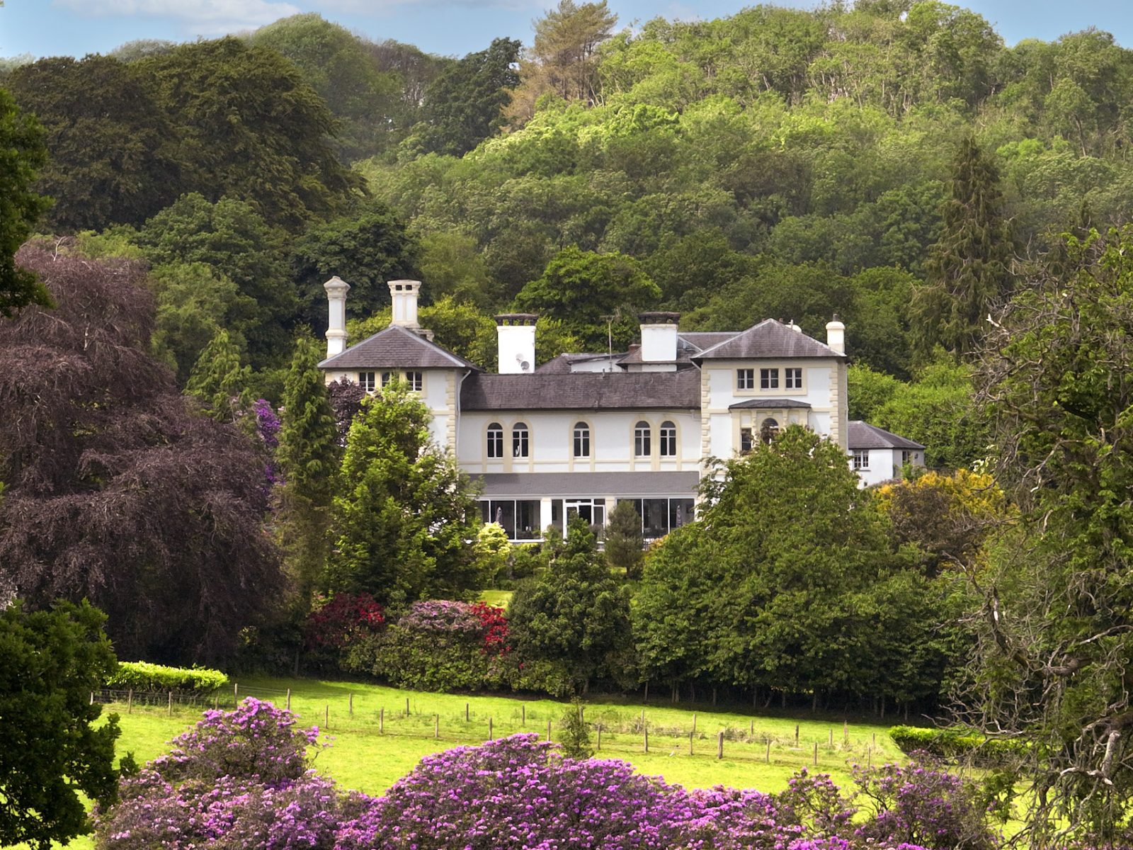 Countryside Mansion surrounded by trees and gardens in Wales