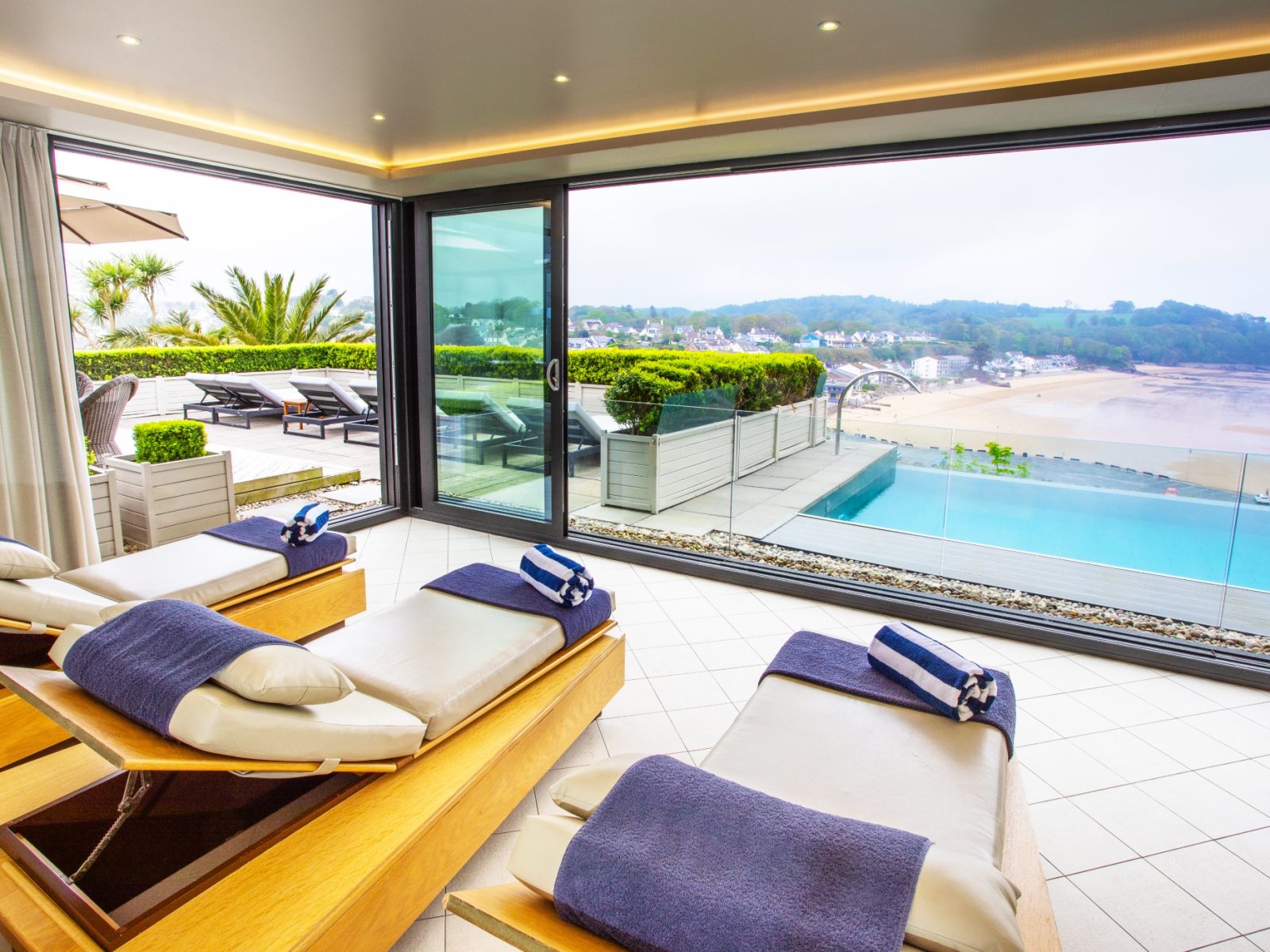 Outdoor hydrotherapy pool with jacquzzi with sea views overlooking St Brides Bay Pembrokeshire coast at boutique spa hotel in Wales